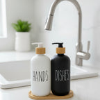 Two soap dispensers, one labeled 'HANDS' and the other 'DISHES', on a wooden stand with a white background.