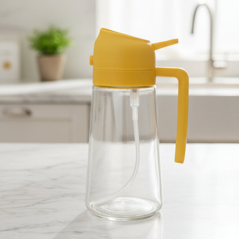 Clear glass bottle with yellow lid and handle on a textured gray background